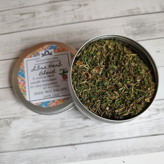 Libra Zodiac Herb blend in a open tin on wood backgrouns