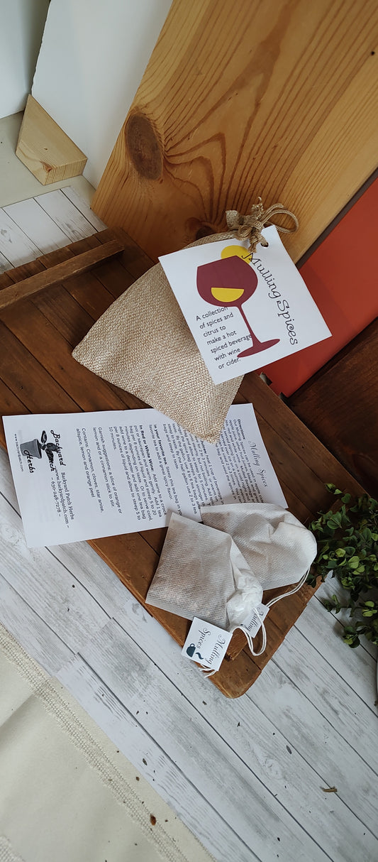 Mulling spices in tea bags with directions and burlap bag and tag in background