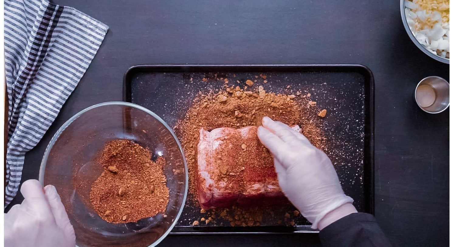Patting 4 Spice Meat Rub on a pork loin