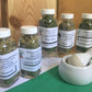 Set of five Herb Seasoning jars with a mortor and pestle in front