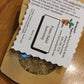 Eco kraft bag of Herbal seasoning labeled Potato Salad Seasoning on a wooden surface